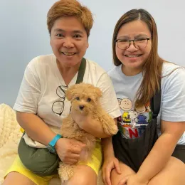 A Curious Tails customer with their new puppy in Singapore