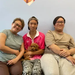 A Curious Tails customer with their new puppy in Singapore