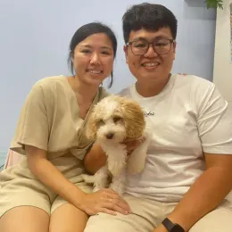 A Curious Tails customer with their new puppy in Singapore