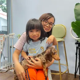 A Curious Tails customer with their new puppy in Singapore