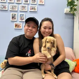 A Curious Tails customer with their new puppy in Singapore