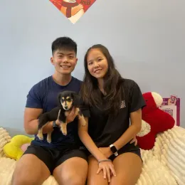 A Curious Tails customer with their new puppy in Singapore