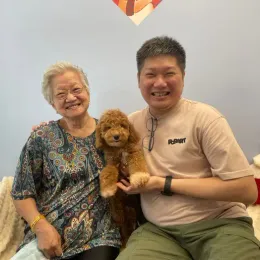 A Curious Tails customer with their new puppy in Singapore